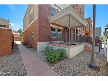 Charming brick townhome with covered front porch and attractive landscaping at 625 S Roosevelt St, Tempe, AZ 85281