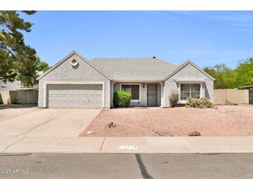 Charming single-story home featuring a well-maintained gray exterior, desert landscaping, and an attached two-car garage at 7114 W Yucca St, Peoria, AZ 85345