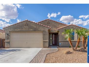 Charming single story home with a two car garage, desert landscaping, and a tile roof at 716 W Blue Ridge Dr, San Tan Valley, AZ 85140