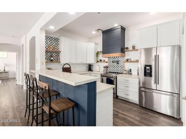 Charming kitchen with stainless steel appliances, modern finishes, and a breakfast bar for casual dining at 7445 E Eagle Crest Dr # 1145, Mesa, AZ 85207