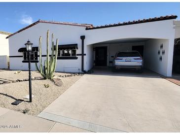 Charming single-story home featuring a covered carport and well-maintained desert landscaping at 7643 E Rancho Vista Dr, Scottsdale, AZ 85251
