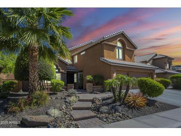 Charming two-story home with well-manicured landscaping, inviting curb appeal, and a beautiful desert sunset at 768 E Mountain Sky Ave, Phoenix, AZ 85048