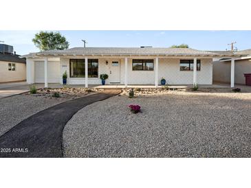 Charming single-story home with a desert landscape and a welcoming covered porch at 8524 E Mariposa Dr, Scottsdale, AZ 85251