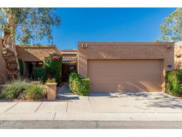 Charming single-story home featuring a two-car garage and lush landscaping in a well-maintained community at 1010 E Lois Ln, Phoenix, AZ 85020