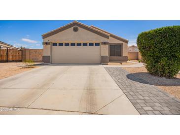 Charming single-story home with a two-car garage and well-maintained landscaping in a quiet neighborhood at 14809 N El Frio Cir, El Mirage, AZ 85335
