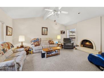 Bright living room featuring a fireplace and comfortable seating arrangement at 16276 E Rosetta Dr # 58, Fountain Hills, AZ 85268