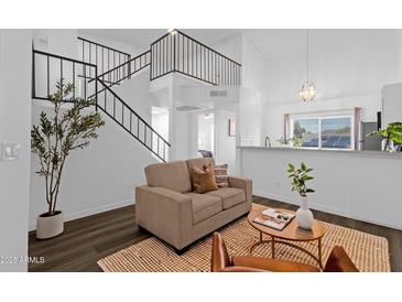 Bright living room featuring a comfortable couch, modern staircase, and stylish decor accents at 19601 N 7Th St # 2095, Phoenix, AZ 85024
