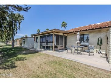 An inviting back patio with dining table and chairs, perfect for outdoor entertaining at 2311 S Farnsworth Dr # 81, Mesa, AZ 85209