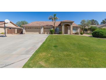 Charming home featuring a well-maintained lawn, mature landscaping, and a three-car garage at 3784 E Simpson Ct, Gilbert, AZ 85297