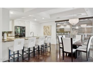 Bright, open kitchen with breakfast bar, white cabinets, and modern stainless steel appliances at 7151 E Rancho Vista Dr # 3001, Scottsdale, AZ 85251