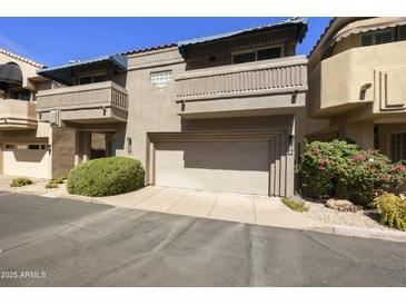 Multi-level townhome featuring a two-car garage and well-maintained landscaping in a desirable neighborhood at 7240 N Dreamy Draw Dr # 109, Phoenix, AZ 85020