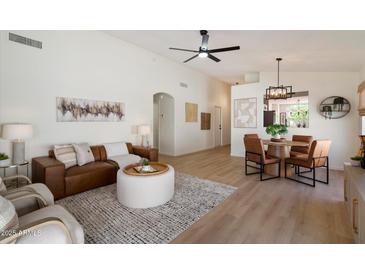 Inviting living room features stylish furnishings, open layout to dining, and modern decor accents at 9143 W Kings Ave, Peoria, AZ 85382