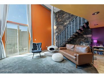 Inviting living room featuring a unique fireplace, stone staircase, and modern design at 1123 E Maryland Ave # 4, Phoenix, AZ 85014