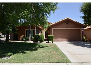 Charming single-story home featuring a well-maintained lawn and a two-car garage, in a suburban neighborhood at 12965 N 95Th Way, Scottsdale, AZ 85260