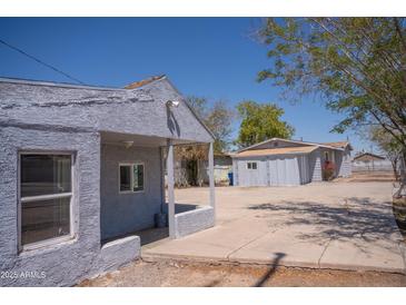 Charming single-story home with a covered porch and spacious concrete driveway at 1410 S 24Th Ave, Phoenix, AZ 85009