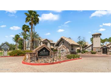 Inviting condominium community entrance with stone signage, tropical landscaping, and well-maintained exterior at 14145 N 92Nd St # 1084, Scottsdale, AZ 85260