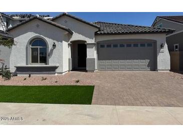 Charming single-story home with a two-car garage and well-manicured front lawn at 15642 W Georgia Dr, Surprise, AZ 85379