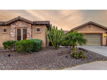 Desert landscaping highlights this charming single Gathering home with a two car garage at 20558 N 263Rd Dr, Buckeye, AZ 85396
