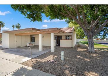 Charming single-story home with covered parking, desert landscaping, and mature shade tree at 2407 W Rue De Lamour Ave, Phoenix, AZ 85029