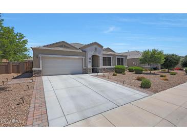 Charming single-story home showcasing a well-manicured lawn and a spacious two-car garage with a wide driveway at 30446 W Picadilly Rd, Buckeye, AZ 85396