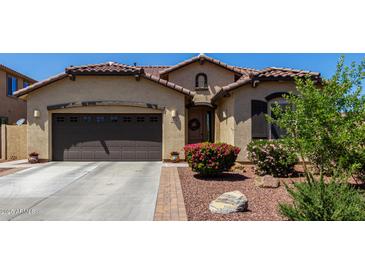 Beautiful single-story home with a two-car garage, desert landscaping, and a charming entryway at 3578 E Walnut Rd, Gilbert, AZ 85298