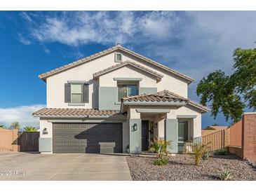 Charming two-story home with a well-manicured front yard, neutral tones, and a two car garage at 38659 N Alamo Ct, San Tan Valley, AZ 85140