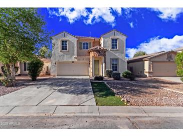 Charming two-story home with a two car garage and beautiful stone accents around the front door at 45018 W Sage Brush Dr, Maricopa, AZ 85139
