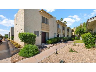 Charming two-story condo with well-manicured landscaping and a welcoming walkway at 4630 N 68Th St # 265, Scottsdale, AZ 85251