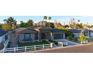Beautiful modern home features desert landscaping, mountain views, and a charming white picket fence at 4714 E Lewis Ave, Phoenix, AZ 85008