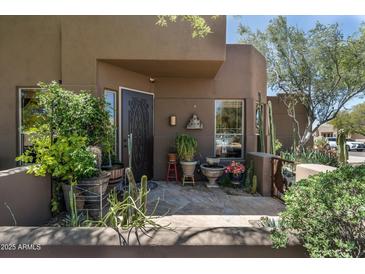 Inviting front entrance featuring mature plants and a well-designed doorway at 9543 E Kiisa Dr, Scottsdale, AZ 85262