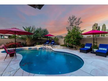 Inviting pool with lounge chairs and umbrellas, perfect for relaxation and outdoor enjoyment at 13533 N 91St Way, Scottsdale, AZ 85260