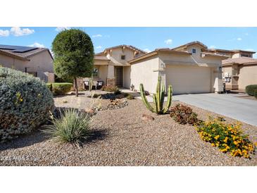 Charming single-story home featuring desert landscaping, a two-car garage, and a cozy front porch at 16466 W Lariat Ln, Surprise, AZ 85387
