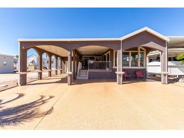 Inviting home featuring a covered carport and charming front porch area at 17200 W Bell Rd # 1202, Surprise, AZ 85374