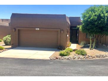 Charming single story home with a desert landscape, two car garage and cozy curb appeal at 19115 E Buckskin Ct, Rio Verde, AZ 85263