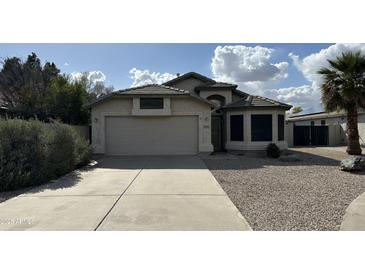 Charming single-story home with a well-maintained front yard and a two-car garage at 19976 N 63Rd Dr, Glendale, AZ 85308