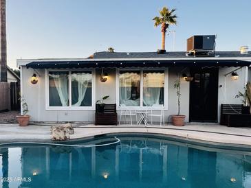 Inviting backyard with a sparkling pool and covered patio, perfect for relaxation and entertaining at 2459 E Baltimore St, Mesa, AZ 85213