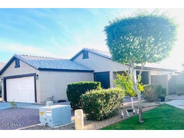 Charming single-story home featuring a two-car garage and well-manicured landscaping at 2618 S 81St Ln, Phoenix, AZ 85043