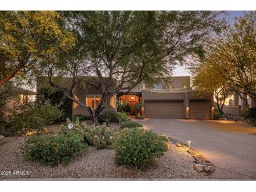 Charming home featuring desert landscaping with mature trees and a spacious driveway to a two-car garage at 29412 N 108Th Pl, Scottsdale, AZ 85262