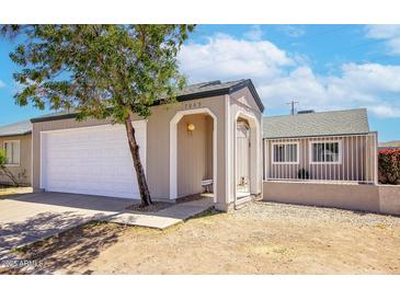Inviting home exterior featuring a well-kept yard, attached garage, and neutral color palette at 7045 S 42Nd St, Phoenix, AZ 85042