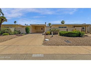 Inviting single-story home featuring a carport and low-maintenance desert landscaping at 9707 W Lancaster Dr, Sun City, AZ 85351