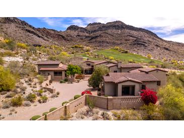 Luxury home features red tile roof, mountain views, and desert landscaping in a serene, upscale neighborhood at 9820 E Thompson Peak Pkwy # 628, Scottsdale, AZ 85255