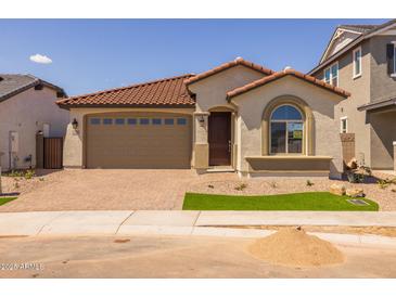 Charming single-story home with a red tile roof, two-car garage, and low maintenance desert landscaping at 15796 W Georgia W Dr, Surprise, AZ 85379