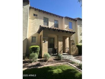 Charming two-story townhouse with a covered porch and well-maintained landscaping at 21166 W Main St, Buckeye, AZ 85396
