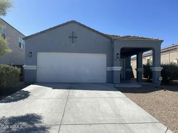 Charming single-story home with a two-car garage, covered porch and desert landscaping at 3602 N 300Th Dr, Buckeye, AZ 85396