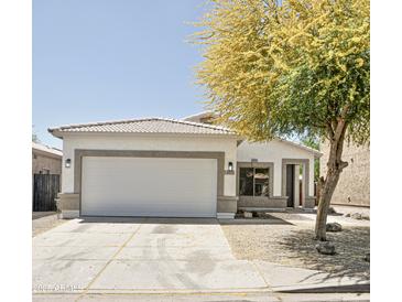 Charming single-story home featuring a two-car garage and a well-maintained front yard with mature tree at 365 E Mountain View Rd, San Tan Valley, AZ 85143