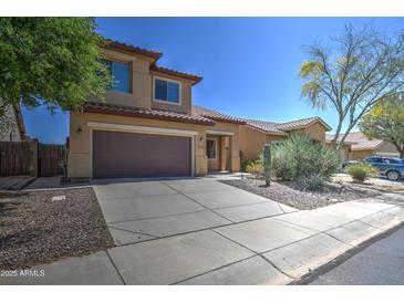 Inviting two-story home with a well-maintained lawn, desert landscaping, and a two-car garage at 40741 N Citrus Canyon Trl, Anthem, AZ 85086