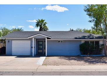 Charming single-story home featuring a well-maintained yard, fresh paint, and an attached one car garage at 7635 E Verde Ln, Scottsdale, AZ 85251