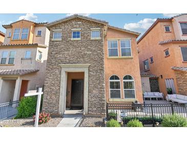 Charming home featuring a stone facade, open porch, and manicured landscaping at 7734 W Terri Lee Dr, Phoenix, AZ 85035