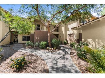 Inviting condo exterior with a well maintained walkway and desert landscaping leading to unit number 13 at 9100 E Raintree Dr # 239, Scottsdale, AZ 85260