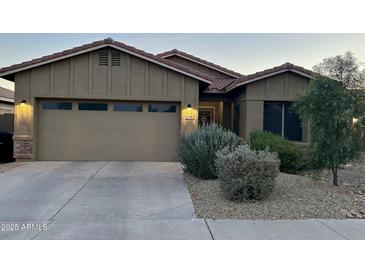 Charming single-Gathering home featuring a two-car garage and well-manicured landscaping at 13783 W Caribbean Ln, Surprise, AZ 85379